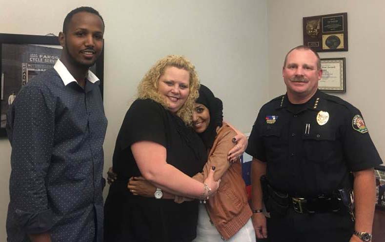 Victim of hate crime, Sarah Hassan hugs her attacker Amber Elizabeth Hensley Thursday at the Fargo Police Department - photo provided by Hukun Abdullahi