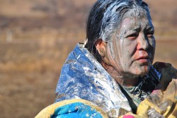 Elderly native woman sprayed by mace, at medics - photo by c.s. hagen