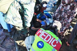 Medics battle hypothermia and hurry to warm activist - photo by c.s. hagen