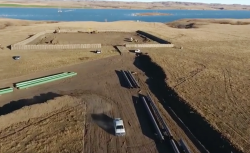 Dapl drill pad with missouri river at lake oahe in distance