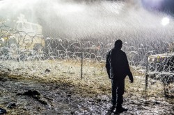 Activist standing under a shower in sub-freezing temperatures - photo by rob wilson photography