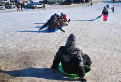 Children sledding down media hill - photo by C.S. Hagen