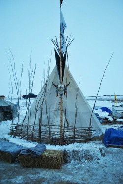 Tipi at Oceti Sakowin, surrounded by hay bales, tipis are far warmer than tents - photo by C.S. Hagen