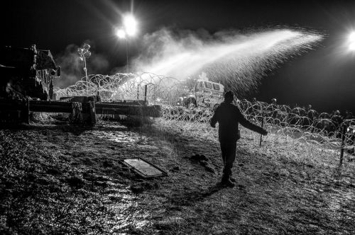 Activist prepares to be hit with water - photograph by Rob Wilson Photography