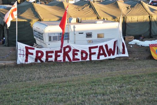 Free Red Fawn banner outside of main entryway to Oceti Sakowin - photograph by C.S. Hagen