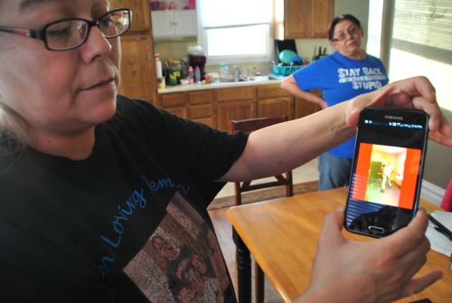 Jackie Charbonneau and Christopher L. Thumb's grandmother, Phyllis Herman, showing video - photograph by C.S. Hagen