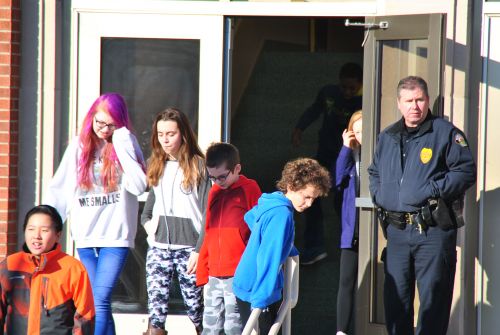 Ben Franklin Middle School's SRO looks on as students walkout of class Wednesday morning - photograph by C.S. Hagen