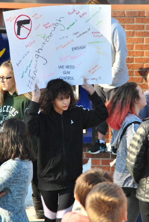 Student holds up a sign during the 17-minute Ben Franklin Middle School walkout - photograph by C.S. Hagen