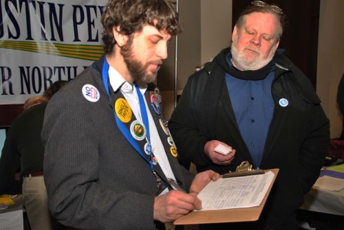 David Dustin Peyer who plans to run for the Senate seat, signs a petition to raise minimum wage to $15 an hour - photograph by C.S. Hagen