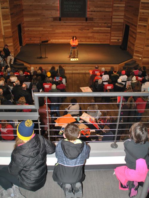 Children listening to Davies High School student and an organizer of March for our Lives Fargo, Madeline Cano speak in front of hundreds of people protesting lack of gun control - photograph by C.S. Hagen