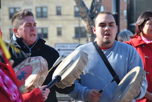 Zebadiah Gartner (right) sings during a march downtown Fargo - photograph by C.S. Hagen