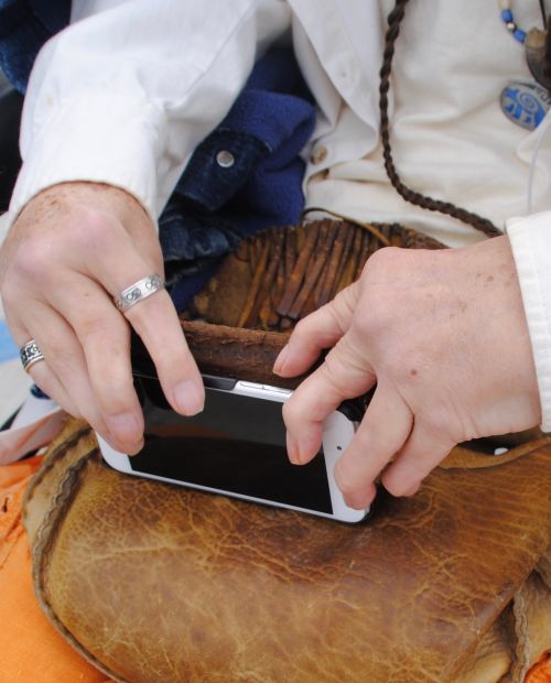 Hands gnarled by an acute arthritic condition, an illness Kevin “NeSe” Shores says is Gulf War Syndrome, he relies on Apps and programs to be able to read - photograph by C.S. Hagen