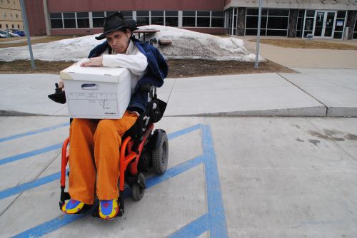 Kevin “NeSe” Shores and his box of paperwork, none of which he can read normally due to what he says is Gulf War Syndrome - photograph by C.S. Hagen