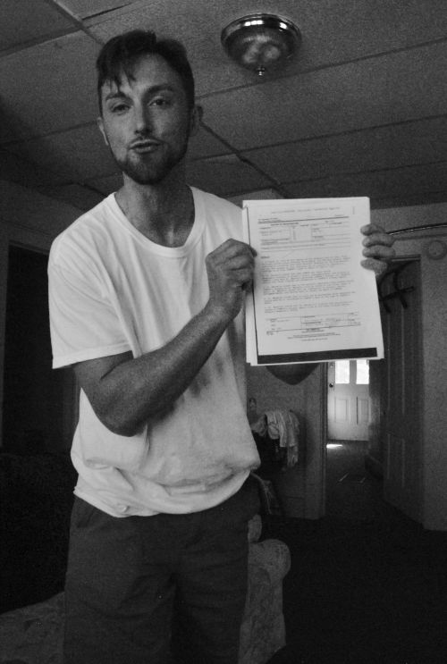 Nathan Evenson holds up the Medical Examiner's report he never saw before pleading guilty - photograph by C.S. Hagen