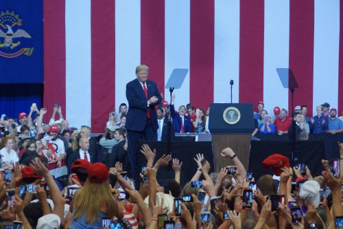 Fans cheering President Trump as he enters Scheels Arena - photograph by C.S. Hagen