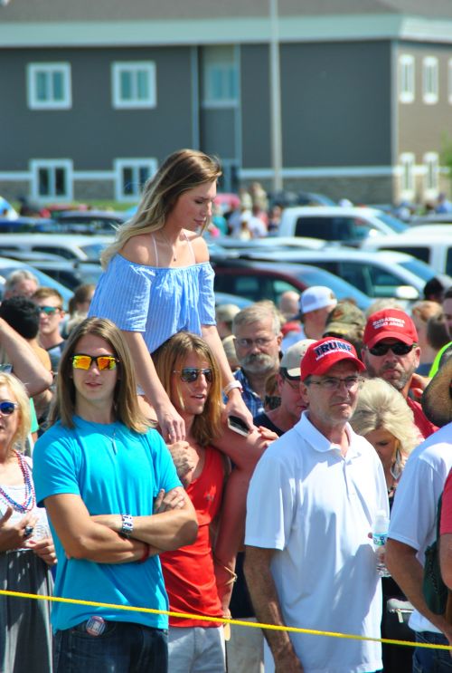 People waiting to hear President Donald Trump speak hours before his scheduled appearance - photograph by C.S. Hagen