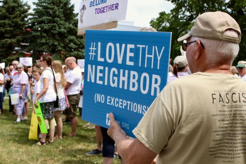 Veteran Ron Saeger, of Fargo, holds up his sign during Fargo rally - photograph by C.S. Hagen