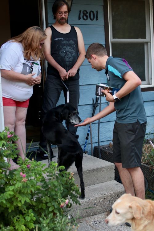 Tim and Marie Donahue with their 10-year-old dogs, Gunnar and Chester talking with Brandon Medenwald - photograph by C.S. Hagen