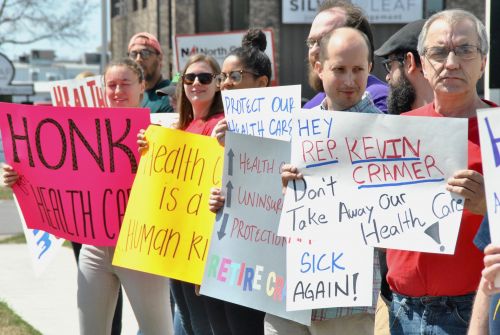 Summer protest outside of Congressman Kevin Cramer's office in Fargo - photograph by C.S. Hagen