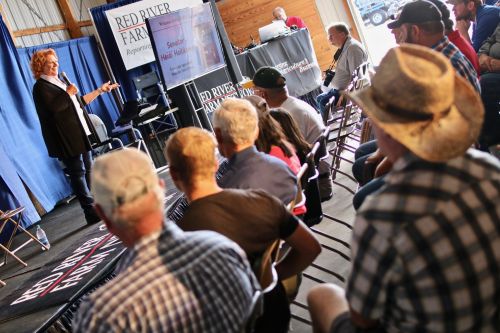 U.S. Senator Heidi Heitkamp speaking before farmers on current policy issues and the trade war - photograph by C.S. Hagen