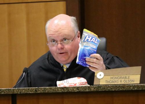 District Court Judge Thomas R. Olson offering cough drops to the defense's attorney - photograph by C.S. Hagen