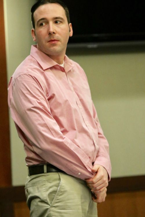 William Hoehn standing in civilian clothes as potential jurrors are being led from the courtroom - photograph by C.S. Hagen