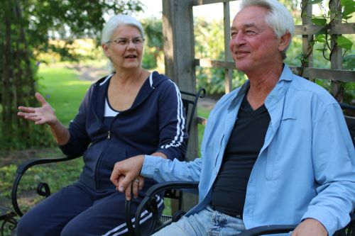 Donald and Cathy Heitkamp in their back yard in Mooreton, ND, discussing their legal struggles against the ND Agricultural Department - photograph by C.S. Hagen