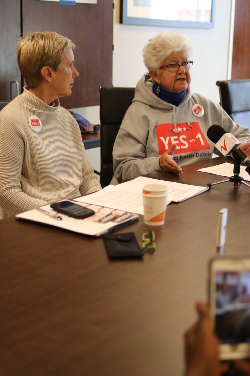 Ellen Chaffee, a founder of North Dakota for Public Integrity, and Dina Burcher talk to the press - photograph by C.S. Hagen