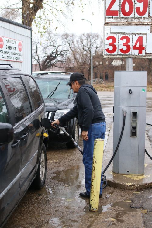 Dale Brave Crow, a South Dakotan Standing Rock Sioux Tribe member fills up on gasoline that the tribe will pay for - photograph by C.S. Hagen