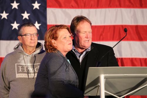 Heidi and brother Joel Heitkamp with Heidi's husband before she concedes the race - photograph by C.S. Hagen