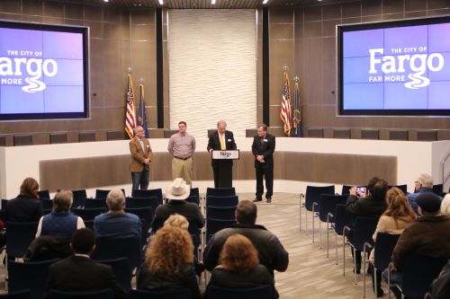 Mayor Tim Mahoney speaks before nearly 100 people in the new City Commissioners chambers - photograph by C.S. Hagen