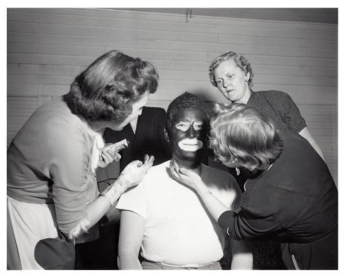 Original cover photograph of a white male in makeup for blackface by three white women at the Fargo Elks Lodge 