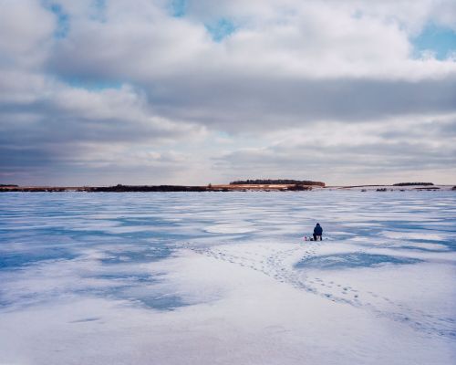 Ice fishing near Eckelson, North Dakota - photograph by Lew Ableidinger