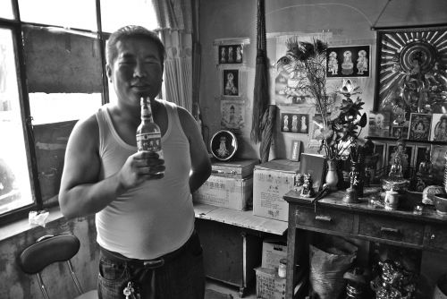 Chen Saiwa, after possession before his altar to the Goddess of Mercy - photograph by C.S. Hagen