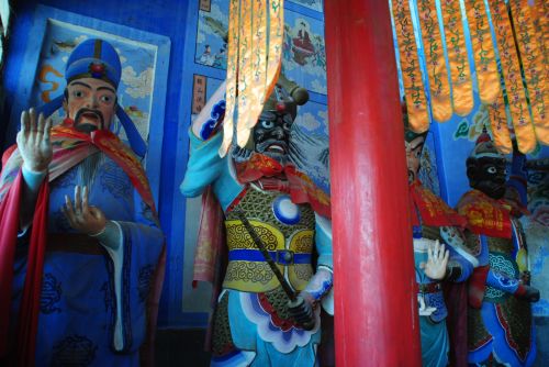 Fox demon, at left, with gods inside the Jie Yin Temple - photograph by C.S. Hagen