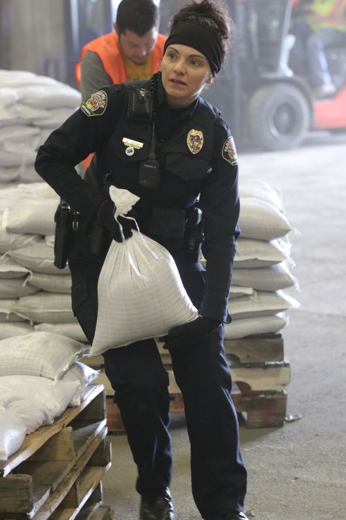 Fargo Police Officer D. Rozich helping sandbag - photograph by C.S. Hagen