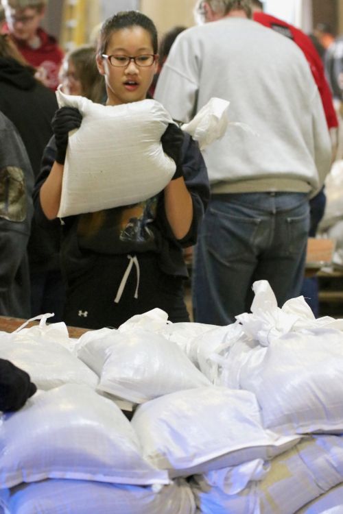 Many schools - primarily 8th graders - from Fargo and West Fargo are volunteering to help sandbag - photograph by C.S. Hagen