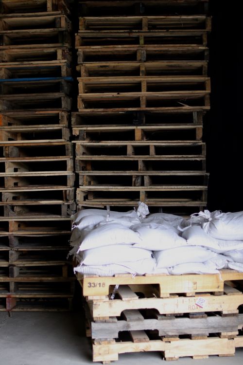 Pallets and sandbags in light - photograph by C.S. Hagen