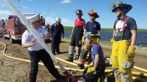 Chief Darrell Graf teaching firefighting techniques 2012 - Facebook