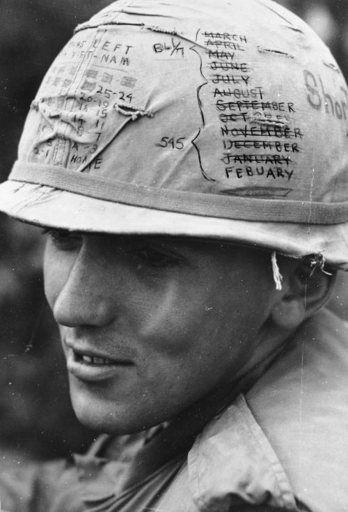 Sky Trooper from the First Cavalry Division Airmobile keeps track of the time he has left on his short time helmet while participating in Operation Pershing near Bong Son - Specialist Frank Moffitt 1968