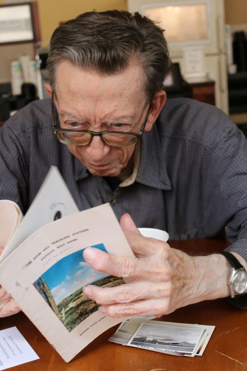 Lowell Busching finding the picture of himself while working for a company on NASA projects - photograph by C.S. Hagen