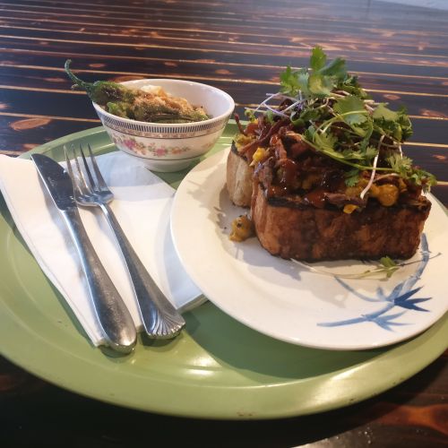 Curried chickpea toast with side of Shishito peppers