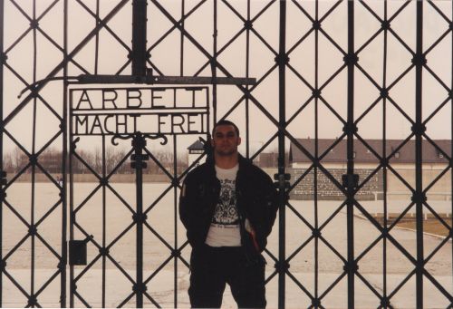 Christian Picciolini at ArbeitMachtFrei gate Dachau 1992 - photograph provided by Jamie Moeller