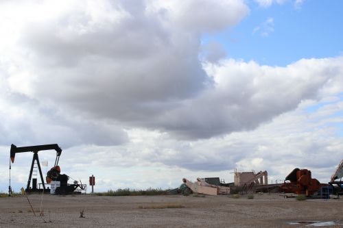 Oil wells and junk and barren land - photograph by C.S. Hagen