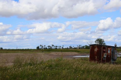 Brine spills and rusted tanks litter the fields in Bottineau County - photograph by C.S. Hagen