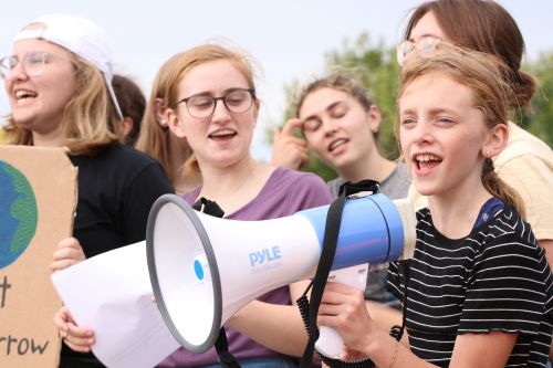 Penelope Echola leading chants at Fargo's climate strike - photograph by C.S. Hagen