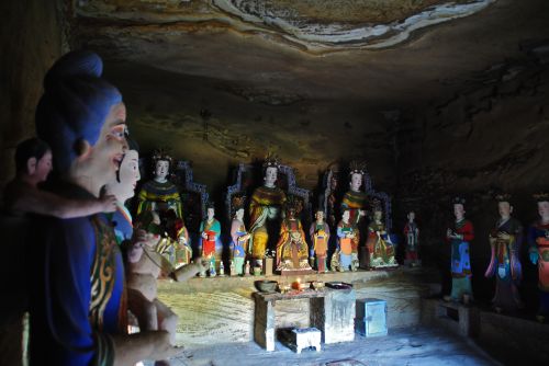 A benevolent family of gods and minor deities in a cave in Shaanxi Province - photograph by C.S. Hagen