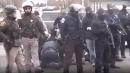 Police knee-ing Aaron Dorn in a dogpile - police cam footage screenshot