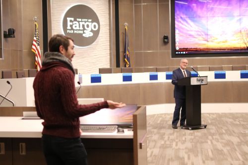 Fargo City Commissioner John Strand listens while residents speak their views on climate change - photograph by C.S. Hagen