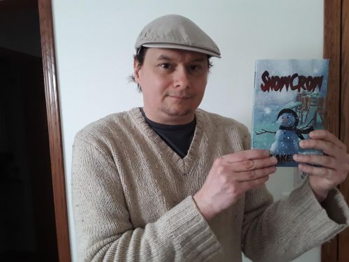 Darrin Albert holding a copy of Snowcrow. photo courtesy of John Showalter